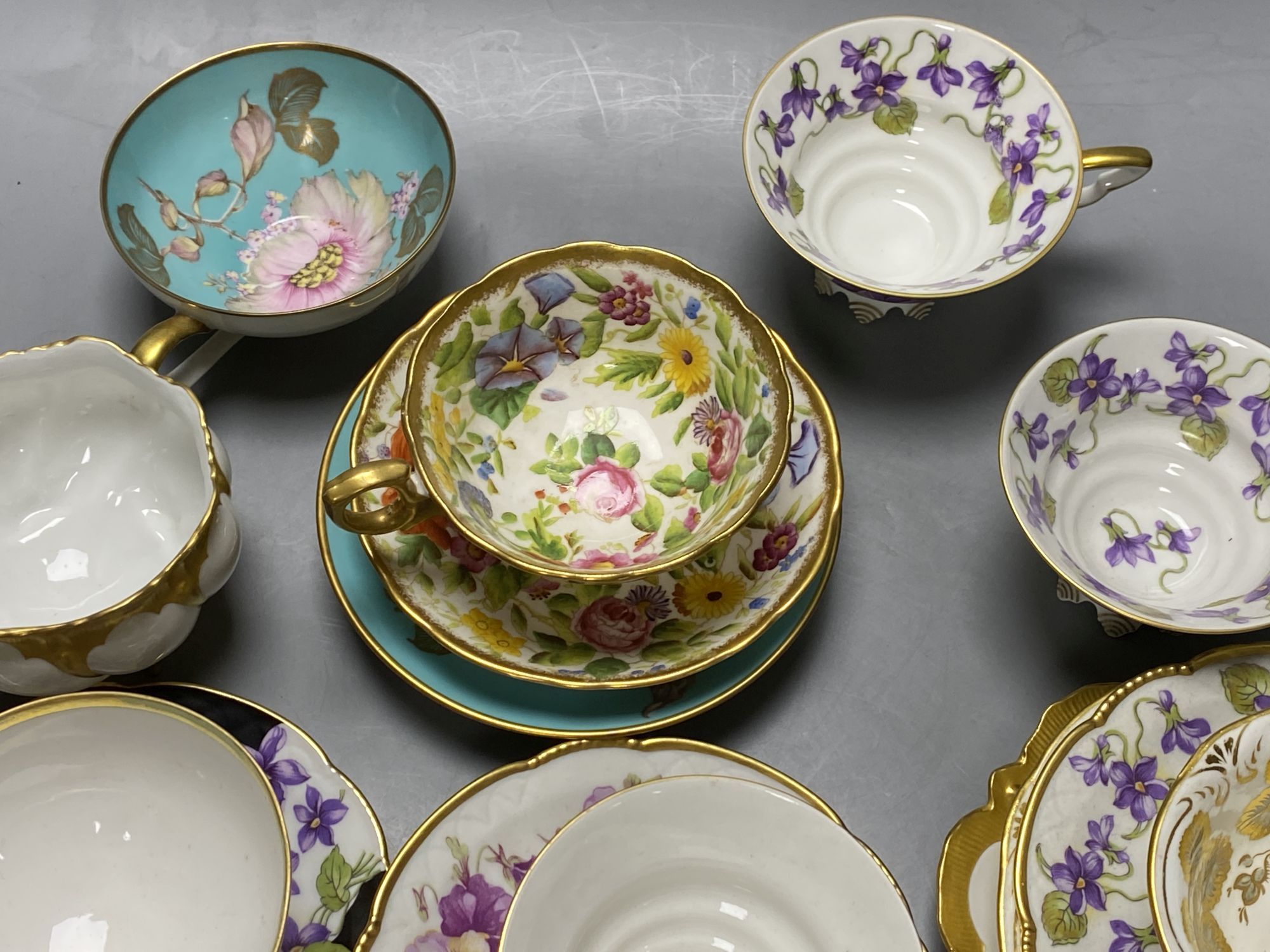 A collection of Continental porcelain tea cups and saucers